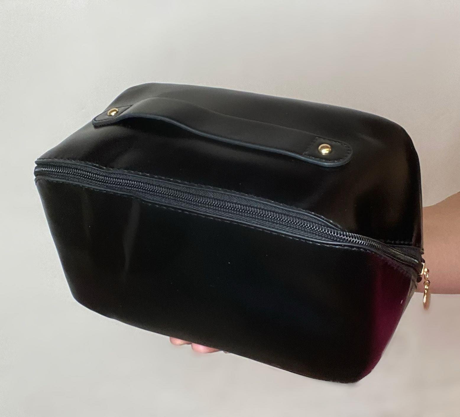 black travel bag with cross zipper