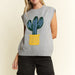 Woman wearing a sleeveless sweater with a cactus design on a beige background