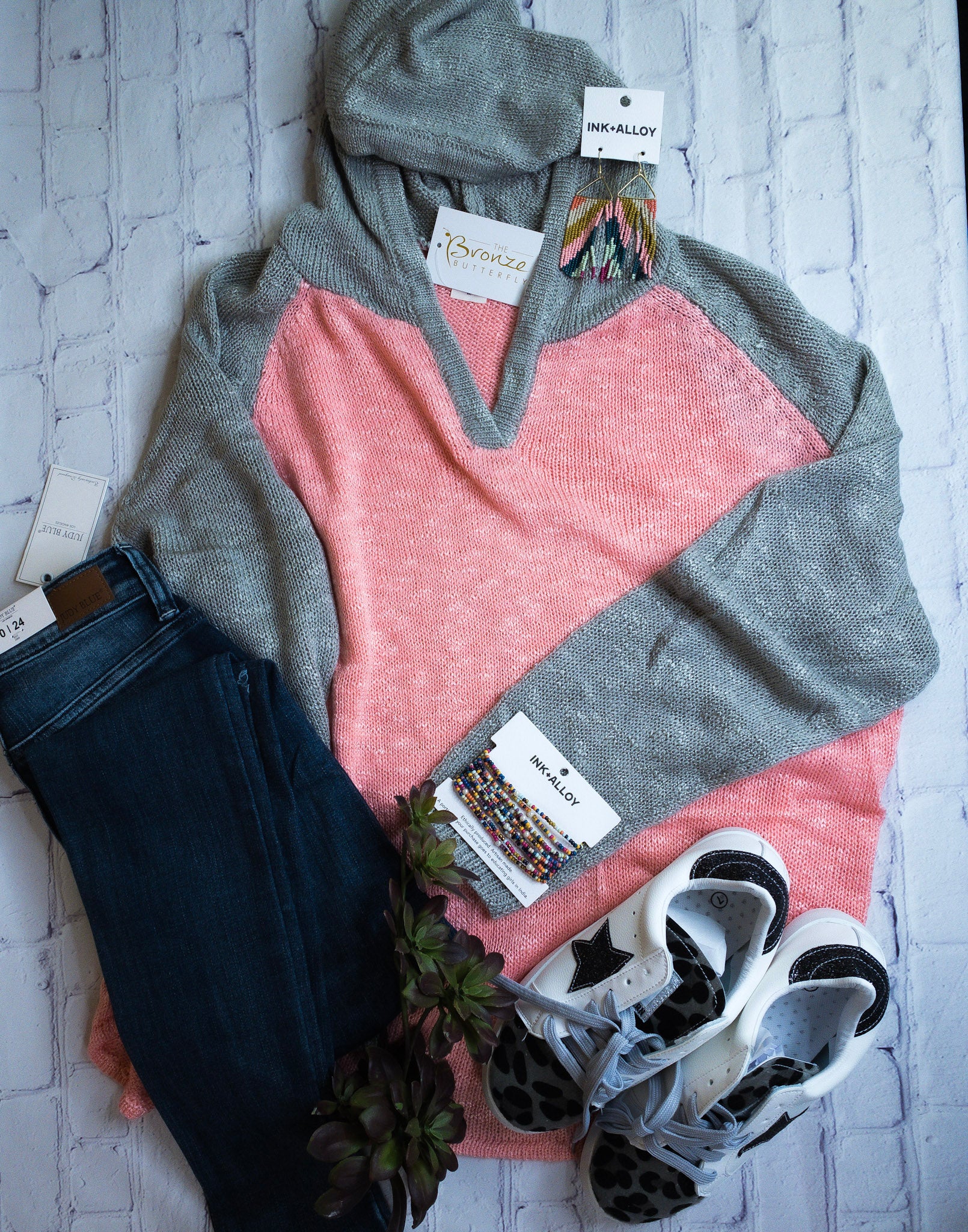 Loose knit blush hooded sweater.